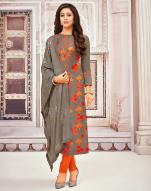 You Will Definitely Earn Lots Of Compliments Wearing This Fancy Designer Suit In Dark Grey And Orange Color. Its Top Is Fabricated Muslin Paired With Santoon Bottom And Chiffon Fabricated Heavy Embroidered Dupatta.