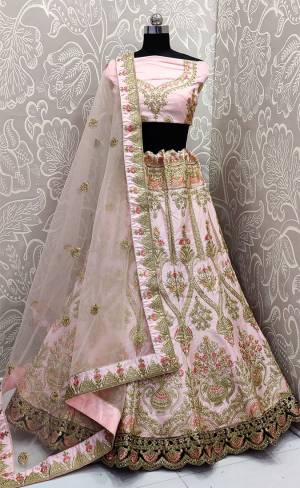 Get ready For The Upcoming Wedding Season With This Heavy Designer Lehenga Choli In Baby Pink Color. This Pretty Heavy Embroidered And Attractive Lehenga Choli Is Fabricated on Satin Silk Paired With Net Fabricated Dupatta. Its Detailed Embroidery And Color Pallete Will earn You Lots Of Compliments From Onlookers. 