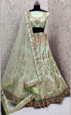 Get ready For The Upcoming Wedding Season With This Heavy Designer Lehenga Choli In Pastel Green Color. This Pretty Heavy Embroidered And Attractive Lehenga Choli Is Fabricated on Satin Silk Paired With Net Fabricated Dupatta. Its Detailed Embroidery And Color Pallete Will earn You Lots Of Compliments From Onlookers. 