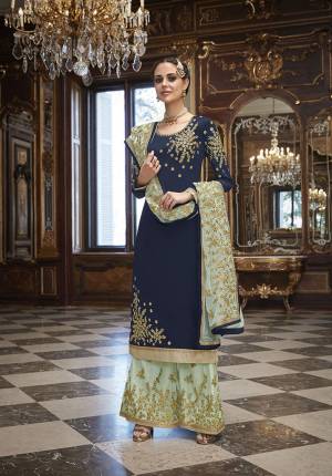 You Will Definitely Earn Lots Of Compliments Wearing This Designer Straight Suit In Navy Blue Colored Top Paired With Aqua Blue Colored Bottom And Dupatta. Its Top Is Fabricated On Georgette Paired With Heavy Embroidered Net Fabricated Bottom And Dupatta. 