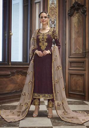 Catch All The Limelight At The Function You Attend Wearing This Heavy Designer Suit In Wine Color Paired With Pastel Pink Colored Dupatta. This Lovely Heavy Embroidered Suit Is Silk Based Paired With Net Fabricated Heavy Embroidered Dupatta. Buy Now. 