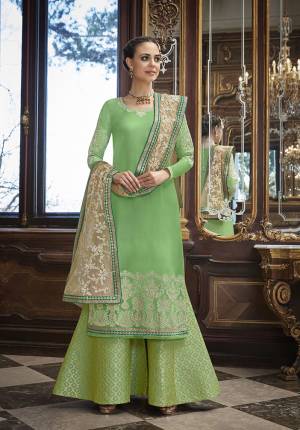 Simple And Elegant Looking Heavy Designer Suit Is Here In Light Green Color Paired With Beige Colored Dupatta. Its Top Is Fabricated On Soft Silk Paired With Jacquard Silk Fabricated Bottom And Net Fabricated Heavy Embroidered Dupatta. 