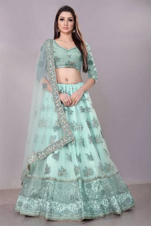 This Wedding Season, Look The Most Graceful Of All Wearing This Heavy Designer Elegant Lehenga Choli In Aqua Blue Color. Its Blouse, Lehenga And Dupatta are Fabricated on Net Beautified With Tone To Tone Coding And Resham Embroidery With Stone Work. Buy Now