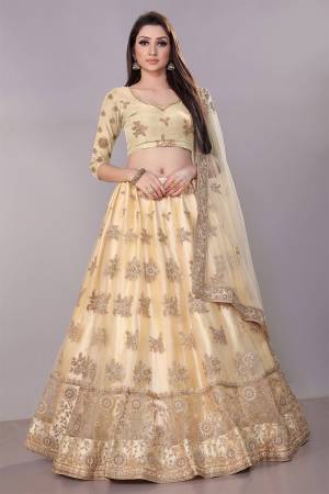 This Wedding Season, Look The Most Graceful Of All Wearing This Heavy Designer Elegant Lehenga Choli In Cream Color. Its Blouse, Lehenga And Dupatta are Fabricated on Net Beautified With Tone To Tone Coding And Resham Embroidery With Stone Work. Buy Now