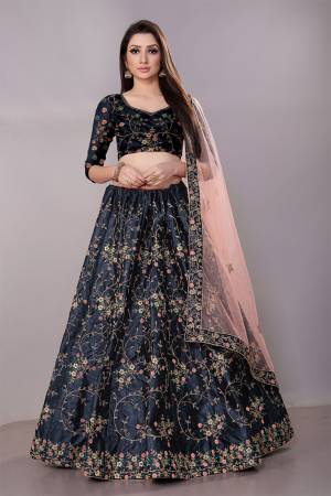 Get Ready For The Upcoming Wedding Season With This Heavy Designer Lehenga Choli In Navy Blue Color Paired With Contrasting Pastel Peach Colored Dupatta. This Pretty Heavy Embroidered And Attractive Lehenga Choli Is Fabricated on Satin Silk Paired With Net Fabricated Dupatta. Its Detailed Embroidery And Color Pallete Will earn You Lots Of Compliments From Onlookers.