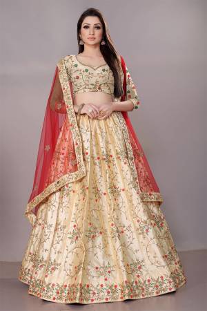 Get Ready For The Upcoming Wedding Season With This Heavy Designer Lehenga Choli In Cream Color Paired With Contrasting Red Colored Dupatta. This Pretty Heavy Embroidered And Attractive Lehenga Choli Is Fabricated on Satin Silk Paired With Net Fabricated Dupatta. Its Detailed Embroidery And Color Pallete Will earn You Lots Of Compliments From Onlookers.