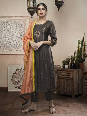 For Your Semi-Casual Wear, Grab This Designer Readymade Suit In Dark Grey Color Paired With Contrasting Orange Colored Dupatta. This Pretty Suit Is Silk Based Paired With Chanderi Silk Fabricated Dupatta. 