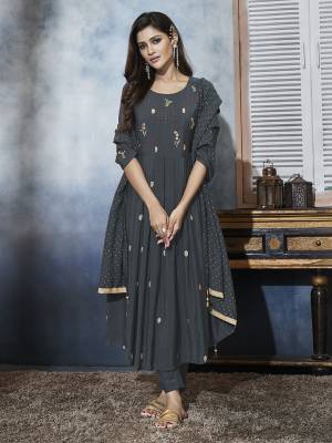 You Will Definitely Earn Lots Of Compliments Wearing This Designer Readymade A-Line Suit In Dark Grey Color. Its Beautiful Top And Dupatta Are Fabricated On Muslin Paired With Satin Bottom. All Its Fabrics are Soft Towards Skin And Ensures Superb Comfort All Day Long. 