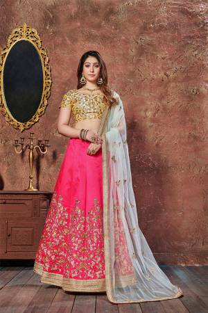 Get Ready For The Upcoming Wedding Season With This Designer Lehenga Choli In Golden Colored Blouse Paired With Dark Pink Colored Lehenga And Baby Blue Colored Dupatta. This Lehenga Choli Is Fabricated On Art Silk Paired With Net Fabricated Dupatta. 