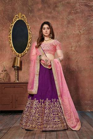 Get Ready For The Upcoming Wedding Season With This Designer Lehenga Choli In Pink Colored Blouse And Dupatta Paired With Purple Colored Lehenga. This Lehenga Choli Is Fabricated On Art Silk Paired With Net Fabricated Dupatta. 