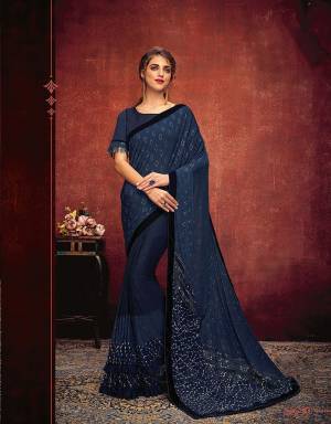 Embellished sequins and decorative cuts give this conventional saree a refreshingly new outlook. Pair with simple studs or tassel earrings and look stunning. 