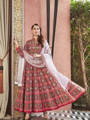 Give An Enhanced Traditional Look To Your Personlity Wearing This Designer Readymade Floor Length Suit In Maroon Color Paired With Contrasting White Colored Dupatta. Its Digital Printed Top Is Silk Based Paired With Cotton Crepe Fabricated Bottom And Net Fabricated Dupatta Which Is Beautified With Sequence Work. 