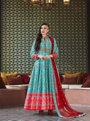 Here Is A Readymade Designer Floor Length Suit In Blue Color Paired With Contrasting Red Colored Dupatta. Its Attractive Printed Top Is Fabricated On Soft Silk Paired With Cotton Crepe Fabricated Bottom And Sequence Worked Net Fabricated Dupatta. This Readymade suit Is Available In All Regular Sizes. Buy Now.