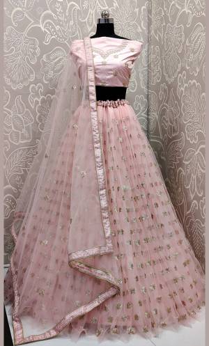 Get Ready For The Upcoming Wedding Season With This Very Beautiful Designer Lehenga Choli In All Over Baby Pink Color. This Heavy Embroidered Lehenga Choli Is Fabricated On Net Beautified With Tone To Tone Embroidery Which Gives A Subtle Look To Your Personality.