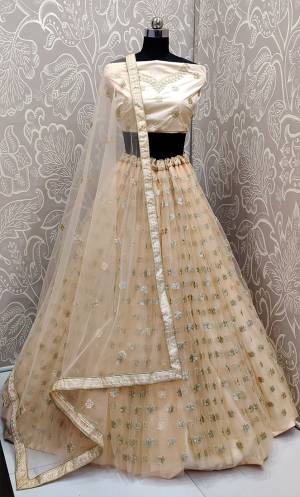 Get Ready For The Upcoming Wedding Season With This Very Beautiful Designer Lehenga Choli In All Over Cream Color. This Heavy Embroidered Lehenga Choli Is Fabricated On Net Beautified With Tone To Tone Embroidery Which Gives A Subtle Look To Your Personality.