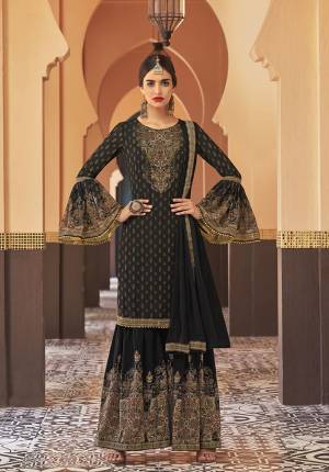 Adorn The Seasons Trend With This Trendy Designer Sharara Suit In Black Color. Its Top Is Fabricated On Georgette Paired With Crepe Satin Bottom And Chiffon Fabricated Dupatta. This Lovely Suit Is Beautified With Detailed Attractive Prints And Stone Work. Buy This Lovely Piece Now.