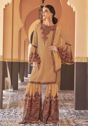 Adorn The Seasons Trend With This Trendy Designer Sharara Suit In Beige Yellow Color. Its Top Is Fabricated On Georgette Paired With Crepe Satin Bottom And Chiffon Fabricated Dupatta. This Lovely Suit Is Beautified With Detailed Attractive Prints And Stone Work. Buy This Lovely Piece Now.