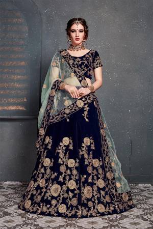 Enhance Your Personality Wearing This Attractive Looking Heavy Designer Lehenga Choli In Navy Blue Color Paired With Sky Blue Colored Dupatta. This Heavy Embroidered Lehenga Choli Is Fabricated On Velvet Paired With Net Fabricated Embroidered Dupatta. 