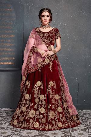 Enhance Your Personality Wearing This Attractive Looking Heavy Designer Lehenga Choli In Maroon Color Paired With Pink Colored Dupatta. This Heavy Embroidered Lehenga Choli Is Fabricated On Velvet Paired With Net Fabricated Embroidered Dupatta. 