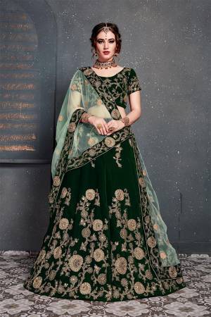 Enhance Your Personality Wearing This Attractive Looking Heavy Designer Lehenga Choli In Dark Green Color Paired With Light Green Colored Dupatta. This Heavy Embroidered Lehenga Choli Is Fabricated On Velvet Paired With Net Fabricated Embroidered Dupatta. 