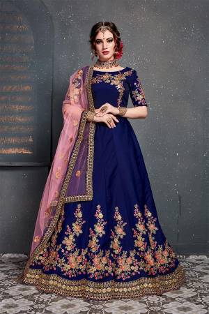 Grab This Heavy Designer Lehenga Choli For This Wedding Season In Royal Blue Color Paired With Contrasting Pink Colored Dupatta. This Pretty Lehenga Choli Is Satin Silk Based Paired With Net Fabricated Dupatta. Buy This Piece Now.