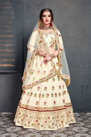 Catch All The Limelight At The Next Wedding You Attend Wearing This Heavy Designer Lehenga Choli In All Over Cream Color. This Lehnega Choli Is Slub Silk Based Paired With Net Fabricated Dupatta.