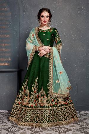 Grab This Heavy Designer Lehenga Choli For This Wedding Season In Dark Green Color Paired With Contrasting Sky Blue Colored Dupatta. This Pretty Lehenga Choli Is Satin Silk Based Paired With Net Fabricated Dupatta. Buy This Piece Now.