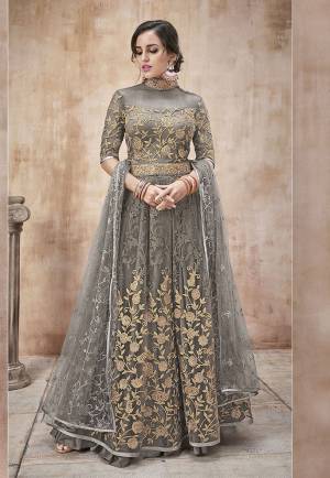 Add This Elegant Shade To Your Wardrobe With This Designer Floor Length Suit In Grey Color. Its Heavy Embroidered Top And Dupatta Are Net Based Paired With Satin Silk Bottom. Buy Now.