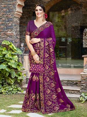 Get Ready For The Upcoming Wedding And Festive Season With This Designer Saree In Purple Color Paired With Purple Colored Blouse. This Heavy Embroidered Saree Is Satin Georgette Based Paired With Art Silk Fabricated Blouse. 
