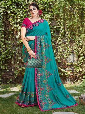 Get Ready For The Upcoming Wedding And Festive Season With This Designer Saree In Turquoise Blue Color Paired With Contrasting Dark Pink Colored Blouse. This Heavy Embroidered Saree Is Satin Silk Based Paired With Art Silk Fabricated Blouse. 