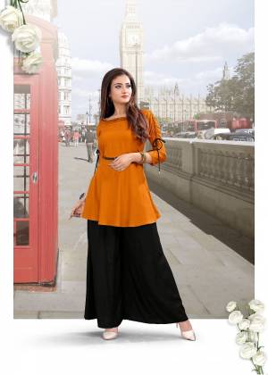 Here Is A Trendy Pair Of Top With Plazzo In Rust Orange And Black Color. This Lovely Readymade Pair Is Fabricated On Rayon And It Is Avialable In All Sizes. 