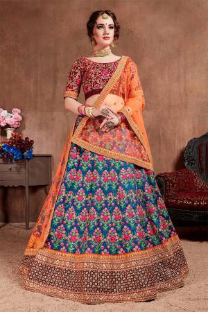 Go Colorful With This Attractive Designer Lehenga Choli In Maroon Colored Blouse Paired With Blue Colored Lehenga And Orange Colored Dupatta. This Lehenga Choli Is Silk Based Paired With Net Fabricated Dupatta. It Is Beautified With Heavy Detailed Embroidery Giving An Attractive Look. 