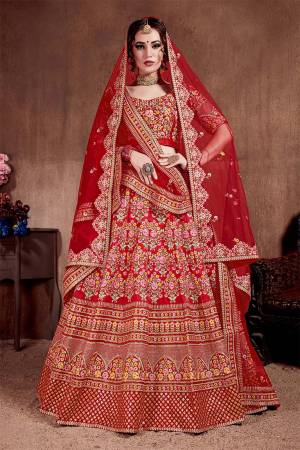 Here Is The Seasons Trending Designer Lehenga Choli In Two Dupatta Concept. This Pretty Lehenga Choli Is In Red With Another Red Colored Dupatta. Its Blouse And Lehenga Are Fabricated On Tafeta Art Silk Paired With Both Net Dupattas. It Has Very Beautiful And Attractive Embroidery. Buy Now.
