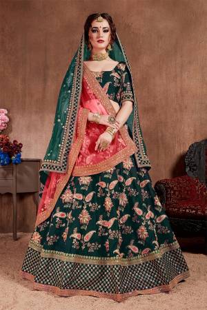 Here Is The Seasons Trending Designer Lehenga Choli In Two Dupatta Concept. This Pretty Lehenga Choli Is In Pine Green With Another Crimson Red Colored Dupatta. Its Blouse And Lehenga Are Fabricated On Tafeta Art Silk Paired With Both Net Dupattas. It Has Very Beautiful And Attractive Embroidery. Buy Now.