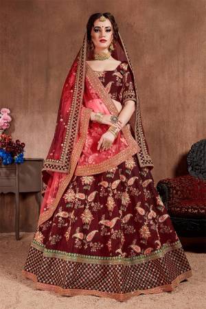 Here Is The Seasons Trending Designer Lehenga Choli In Two Dupatta Concept. This Pretty Lehenga Choli Is In Maroon With Another Crimson Red Colored Dupatta. Its Blouse And Lehenga Are Fabricated On Tafeta Art Silk Paired With Both Net Dupattas. It Has Very Beautiful And Attractive Embroidery. Buy Now.