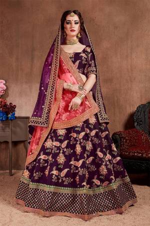 Here Is The Seasons Trending Designer Lehenga Choli In Two Dupatta Concept. This Pretty Lehenga Choli Is In Purple With Another Crimson Red Colored Dupatta. Its Blouse And Lehenga Are Fabricated On Tafeta Art Silk Paired With Both Net Dupattas. It Has Very Beautiful And Attractive Embroidery. Buy Now.