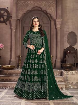Add This Lovely Designer Floor Length Suit to Your Wardrobe In Dark Green Color. Its Beautiful Attractive Embroidered Top and Dupatta are Fabricated On Georgette Paired With Santoon Bottom. This Suir Is Light In Weight And Easy To Carry Throughout The Gala.