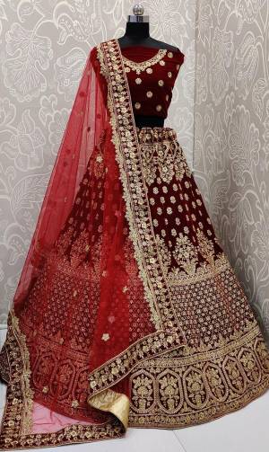 Here Is A Beautiful Designer Bridal Lehenga Choli In Maroon Color Paired With Maroon Colored Dupatta. This Beautiful Heavy Lehenga Choli Is Fabricated On Velvet Paired With Net Fabricated Dupatta. It Is Beautified With Heavy Detailed Embroidery. Get Ready For Your D-Day With This Designer Piece And Look The Most Graceful Of All.