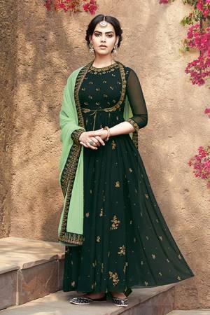 Grab This Very Beautiful Designer Suit In Dark Green Color Paired With Light Green Colored Dupatta. This Pretty Unique Koti Patterned Suit Is Fabricated On Georgette Paired With Santoon Bottom And Net Chiffon fabricated Dupatta. It Is Light In Weight And Easy To Carry All Day Long. 