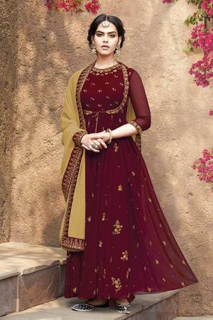 Grab This Very Beautiful Designer Suit In Maroon Color Paired With Beige Colored Dupatta. This Pretty Unique Koti Patterned Suit Is Fabricated On Georgette Paired With Santoon Bottom And Net Chiffon fabricated Dupatta. It Is Light In Weight And Easy To Carry All Day Long. 
