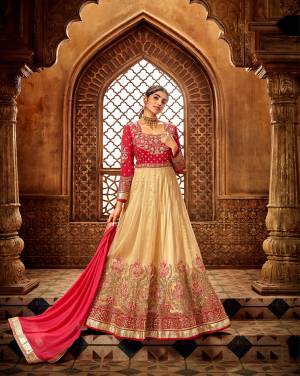 Get Ready For This Wedding Season With This Heavy Designer Floor Length Suit In Cream And Dark Pink Color. This Pretty Suit Is Net Based Paired With Santoon Bottom And Chiffon Fabricated Dupatta. It Is Light Weight And Easy To Carry All Day Long. 