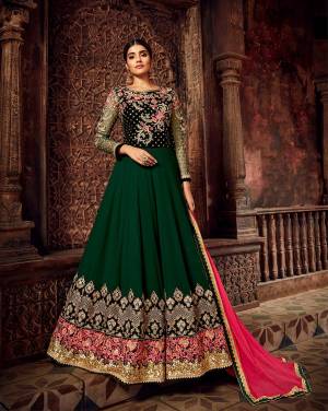 Here Is A Very Beautiful Designer Floor Length Suit In Dark Green And Dark Pink Color. This Beautiful Suit In Fabricated On Georgette With Highlighted Yoke Pattern Fabricated on Velvet, It Is Paired With Santoon Bottom And Chiffon Fabricated Dupatta. Its Pretty Color Pallete And Design Will Definitely Earn You Lots Of Compliments from onlookers. 