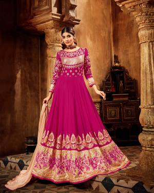 Bright And Visually Appealing Shade Is Here With This Heavy Designer Floor Length Suit In Rani Pink Color Paired With Peach Colored Dupatta. This Pretty Suit Is Georgette Based Paired With Santoon Bottom And Chiffon Fabricated Dupatta. Buy This Lovely And Attractive Looking Designer Piece Now.