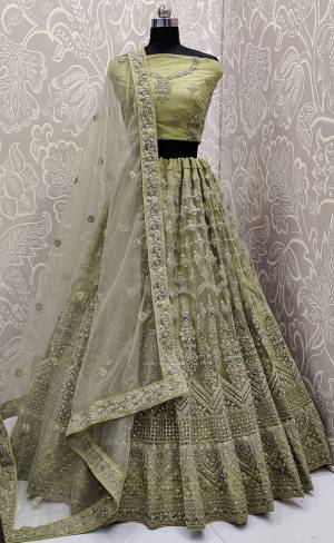 Look The Most Elegant Of All This Wedding Season Wearing This Heavy Designer Lehenga Choli In Olive Green Color. This Beautiful Heavy Tone To Tone Embroidered Lehenga Choli Is Fabricated On Net. Its Rich Color and Detailed Embroidery Will earn You Lots Of Compliments From Onlookers