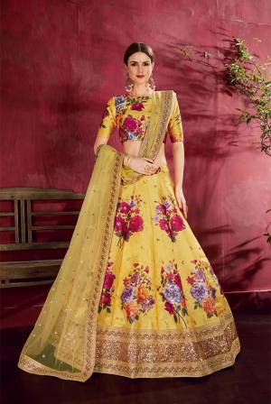 Adorn A Lovely Trendy Look This Wedding Season With This Heavy Designer Lehenga Choli In Yellow Color. This Beautiful Lehenga Choli Is Art Silk Beautified With Attractive Digital Print And Embroidery Paired With Net Fabricated Embroidered Dupatta. Buy This Lovely Lehenga Choli Now.