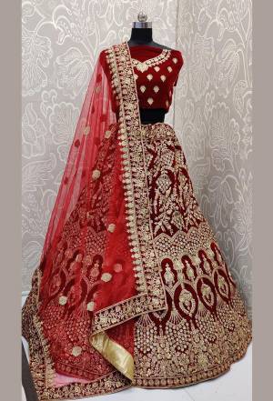 Here Is A Beautiful Designer Bridal Lehenga Choli In Maroon Color?Paired With Red Colored Dupatta. This Beautiful Heavy Lehenga Choli Is Fabricated On Velvet Paired With Net Fabricated Dupatta. It Is Beautified With Heavy Detailed Embroidery. Get Ready For Your D-Day With This Designer Piece And Look The Most Graceful Of All.?