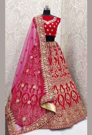 Here Is A Beautiful Designer Bridal Lehenga Choli In Rani Pink Color Paired With Rani Pink Colored Dupatta. This Beautiful Heavy Lehenga Choli Is Fabricated On Velvet Paired With Net Fabricated Dupatta. It Is Beautified With Heavy Detailed Embroidery. Get Ready For Your D-Day With This Designer Piece And Look The Most Graceful Of All