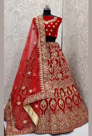 Here Is A Beautiful Designer Bridal Lehenga Choli In Red Color Paired With Red Colored Dupatta. This Beautiful Heavy Lehenga Choli Is Fabricated On Velvet Paired With Net Fabricated Dupatta. It Is Beautified With Heavy Detailed Embroidery. Get Ready For Your D-Day With This Designer Piece And Look The Most Graceful Of All