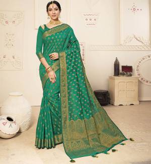 Celebrate This Festive Season In A Lovely Traditional Look With This Designer Saree In Sea Green Color. This Saree Is Fabricated on Banarasi Art Silk Beautified With Heavy Weave Paired with Art Silk Fabricated Blouse. Buy This Rich Looking Saree Now.
