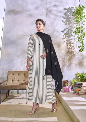 Here Is Pretty Designer Kurti For Your Semi-Casual Or Festive Wear In White And Black Color Paired With Black Colored Designer Embroidered Scarf. This Kurti Is Handloom Cotton Based Paired With Rayon Scarf. 